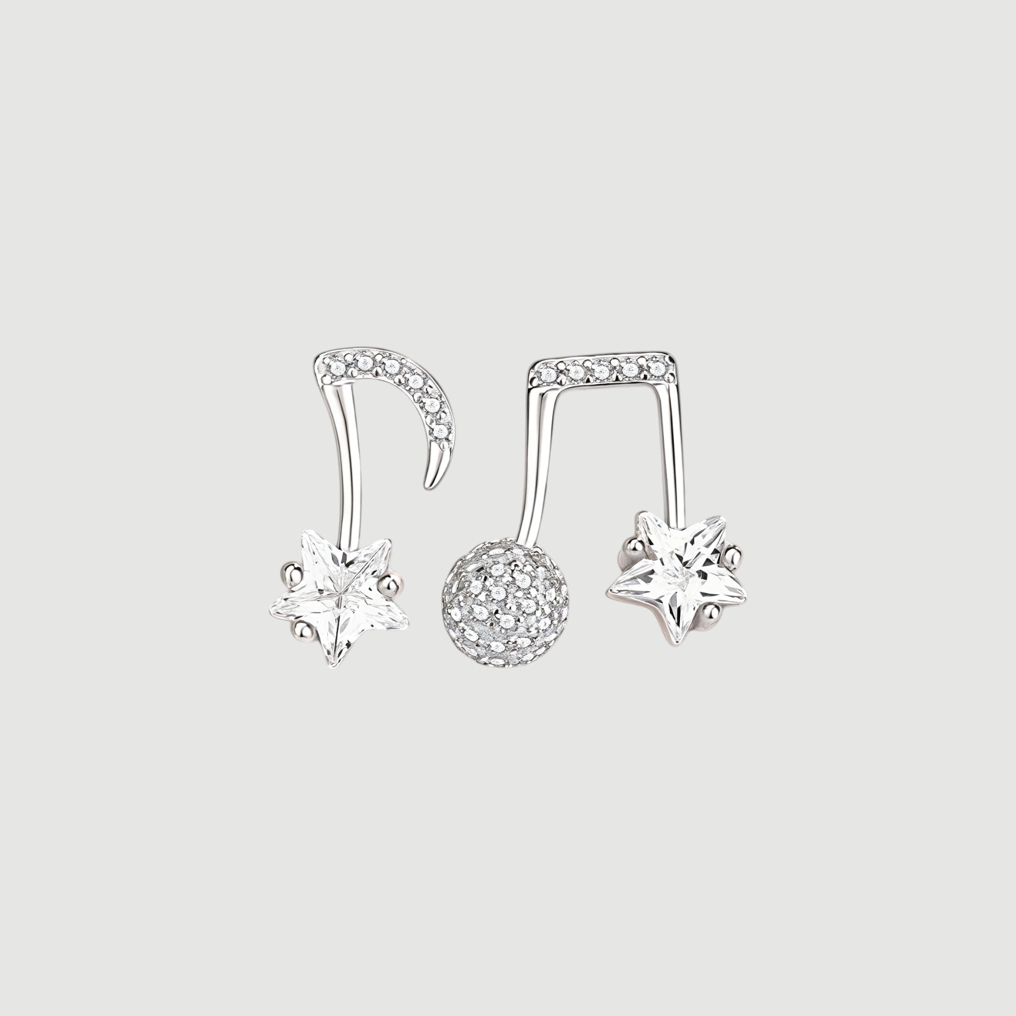 Amara Jewels gold-plated sterling silver asymmetrical music note and star earrings with cubic zirconia.