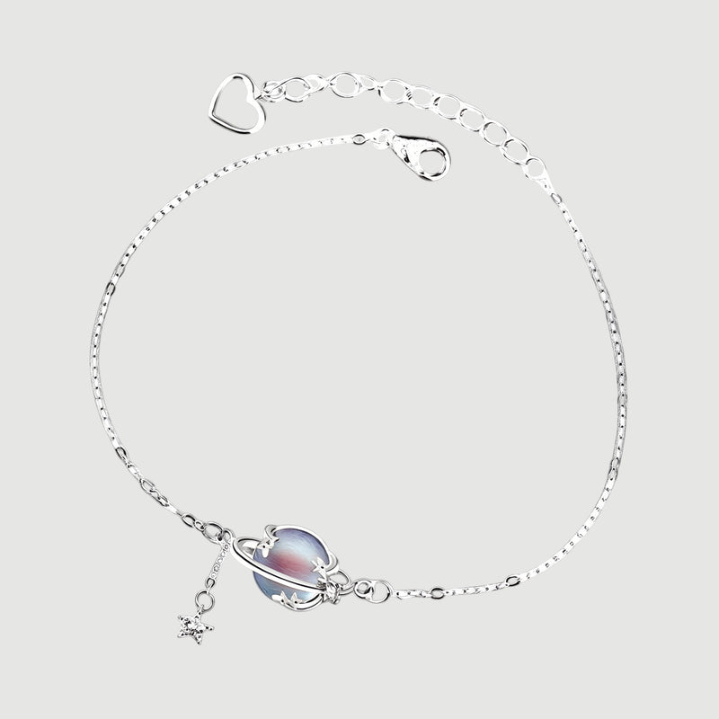 Amara Jewels 925 sterling silver adjustable bracelet with iridescent blue planet charm and dangling star.