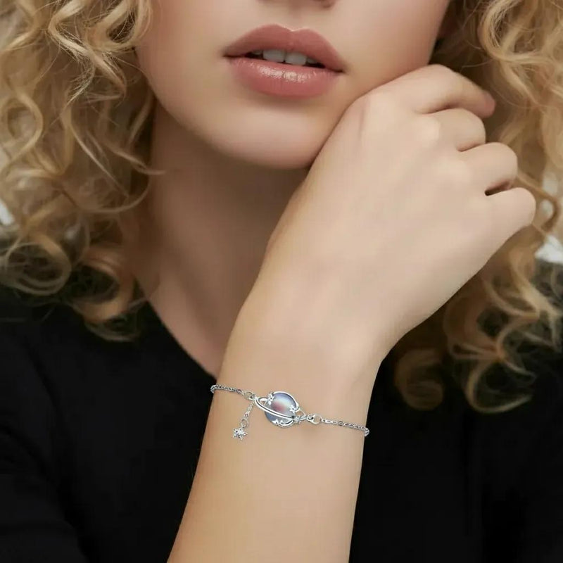 Amara Jewels 925 sterling silver adjustable bracelet with iridescent blue planet charm and dangling star.