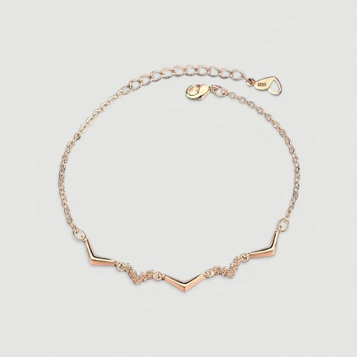 Amara Jewels rose gold chevron bracelet with zircon accents, delicate chain, minimalist design.
