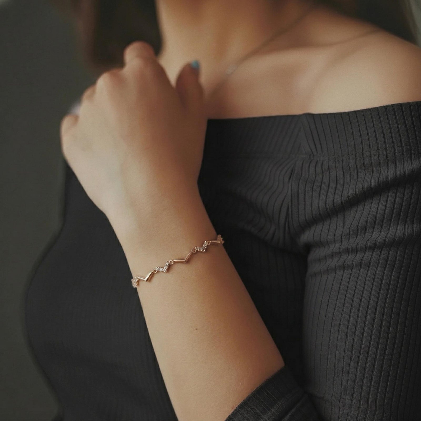 Amara Jewels rose gold chevron bracelet with zircon accents, delicate chain, minimalist design.
