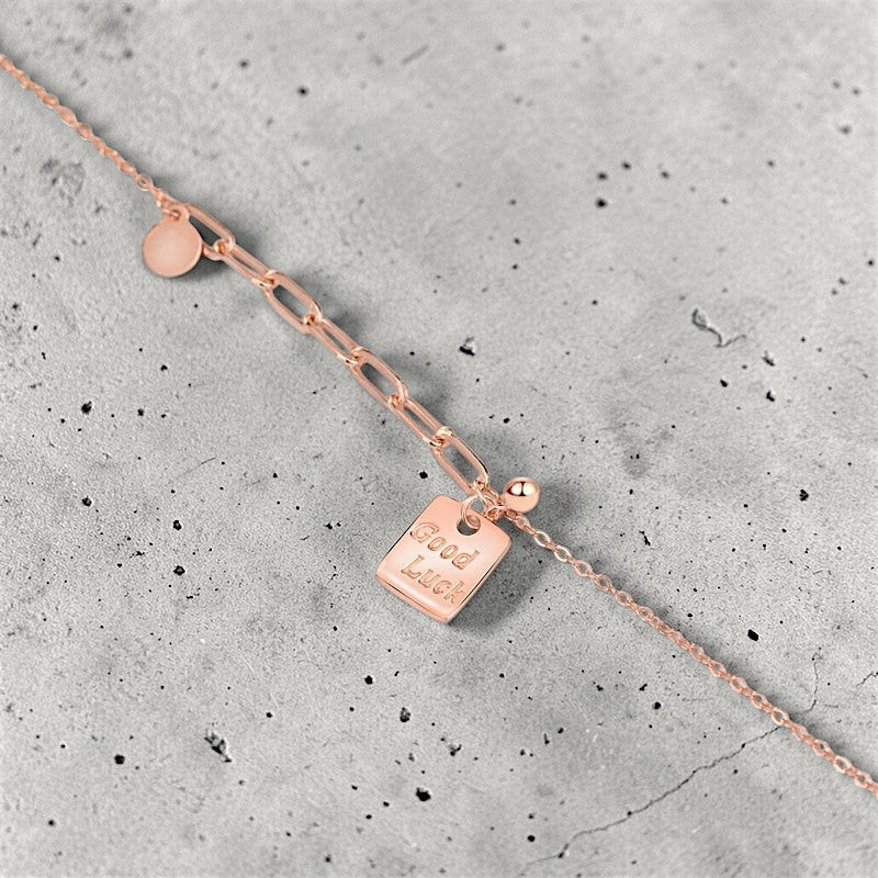 Amara Jewels rose gold plated sterling silver necklace with a square pendant engraved with "Good Luck".