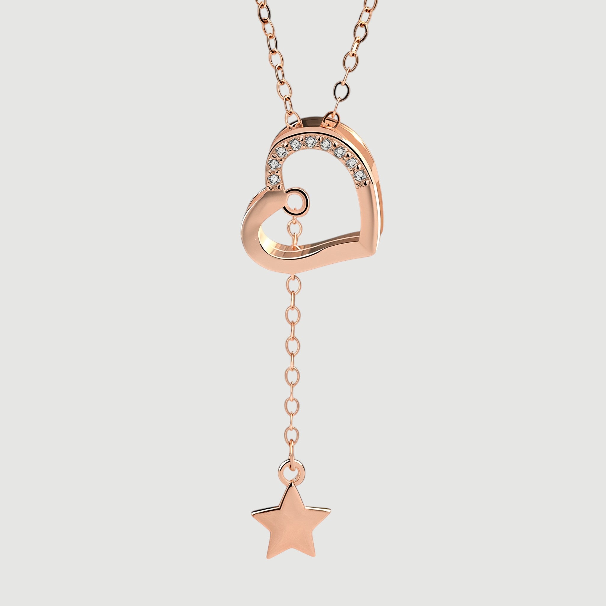 Amara Jewels rose gold tone necklace with heart pendant adorned with cubic zirconia and a dangling star charm.