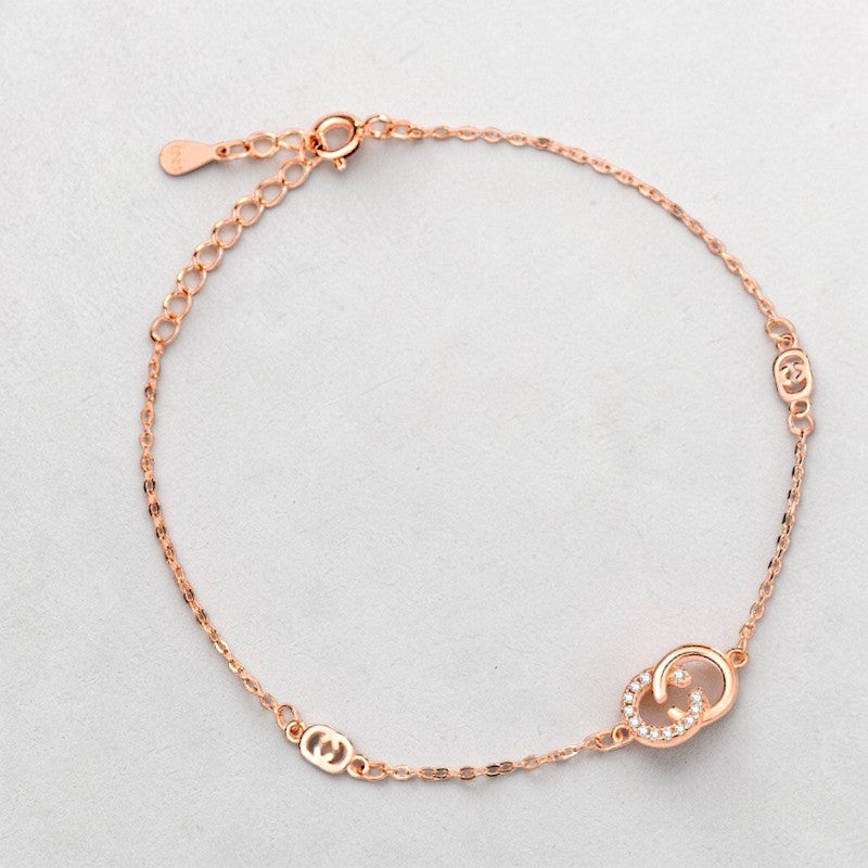 Amara Jewels rose gold 925 sterling silver adjustable chain bracelet with interlocking circles, one adorned with cubic zirconia.