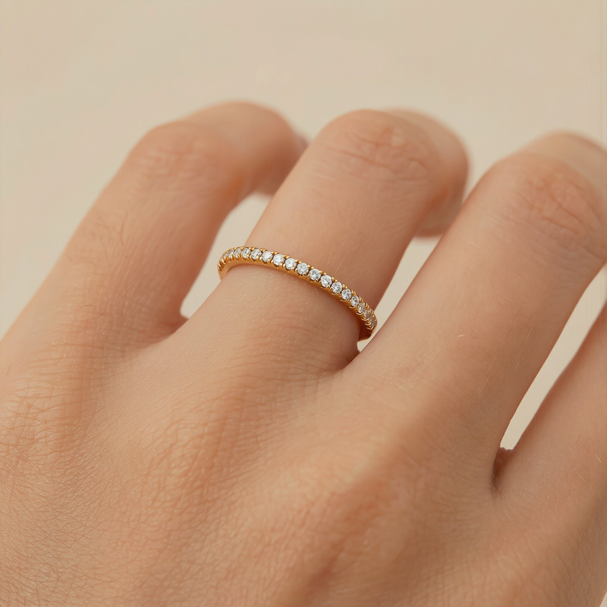 Amara Jewels rose gold stacker ring with clear stones. Minimalist band with a continuous row of shimmering stones.