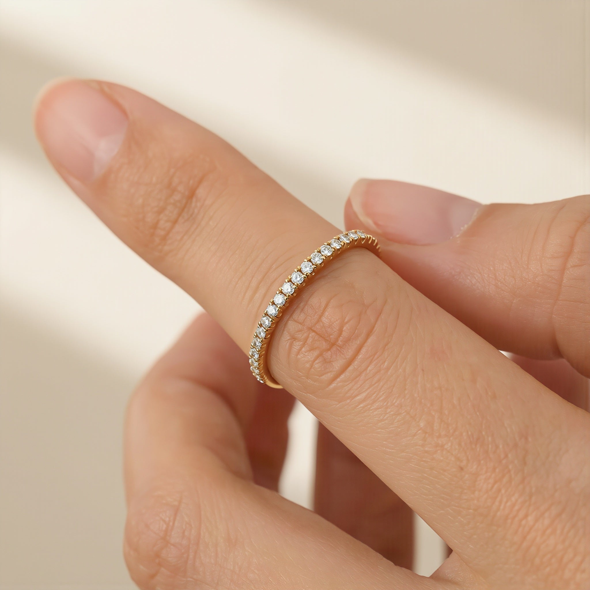 Amara Jewels rose gold stacker ring with clear stones. Minimalist band with a continuous row of shimmering stones.