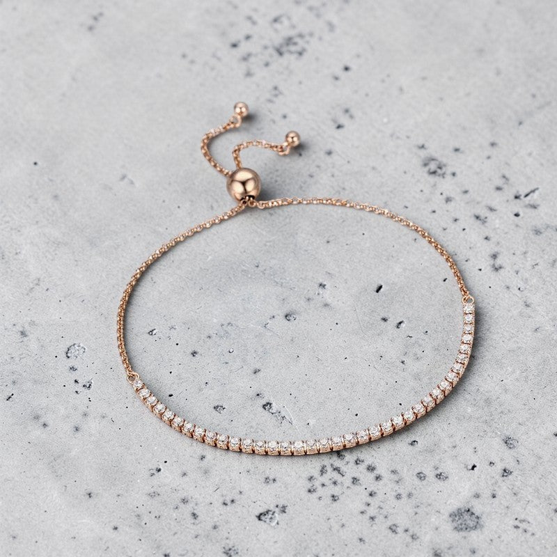 Amara Jewels rose gold adjustable tennis bracelet with white CZ stones and a slider clasp.