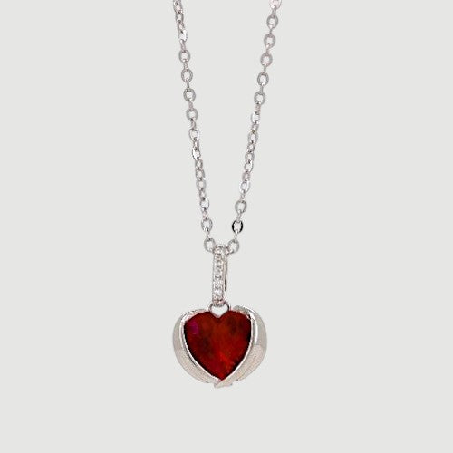 Amara Jewels sterling silver necklace with ruby red heart pendant and delicate chain, adorned with small crystals.