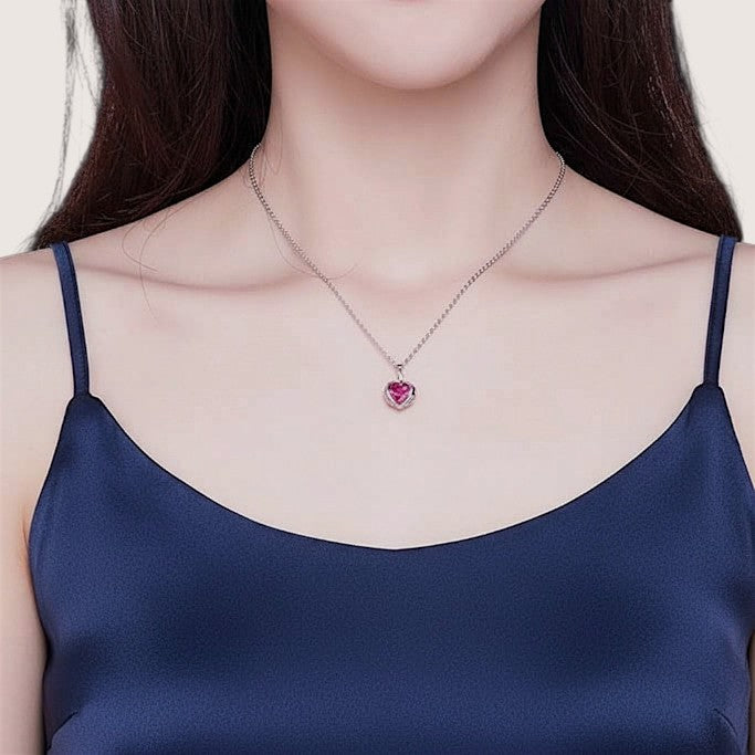 Amara Jewels sterling silver necklace with ruby red heart pendant and delicate chain, adorned with small crystals.