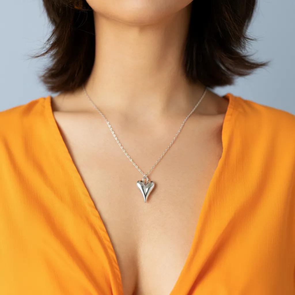 Amara Jewels sculpted heart pendant necklace in polished sterling silver with a delicate chain.
