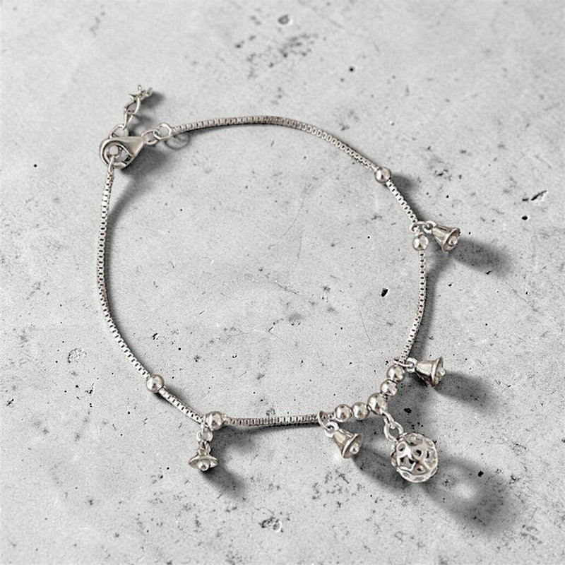 Amara Jewels Sterling Silver bracelet with bell-shaped charms and a hollow oval charm.