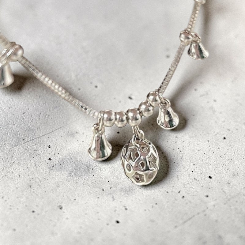 Amara Jewels Sterling Silver bracelet with bell-shaped charms and a hollow oval charm.