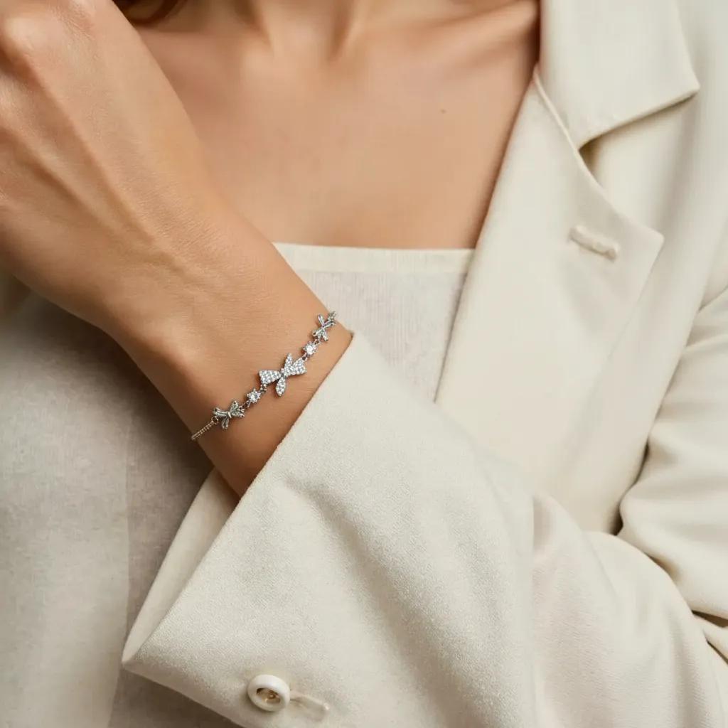 Amara Jewels 925 sterling silver adjustable bracelet with butterfly and floral charms, adorned with sparkling cubic zirconia.