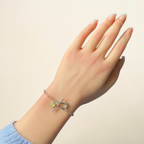 Amara Jewels sterling silver bracelet with paperclip chain, T-bar clasp, and a square citrine-colored charm.