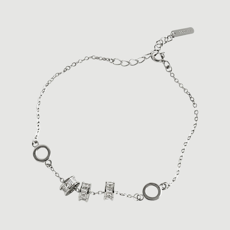 Amara Jewels 925 sterling silver bracelet with geometric charms and adjustable chain. Features circular and bar charms with baguette-cut stones.