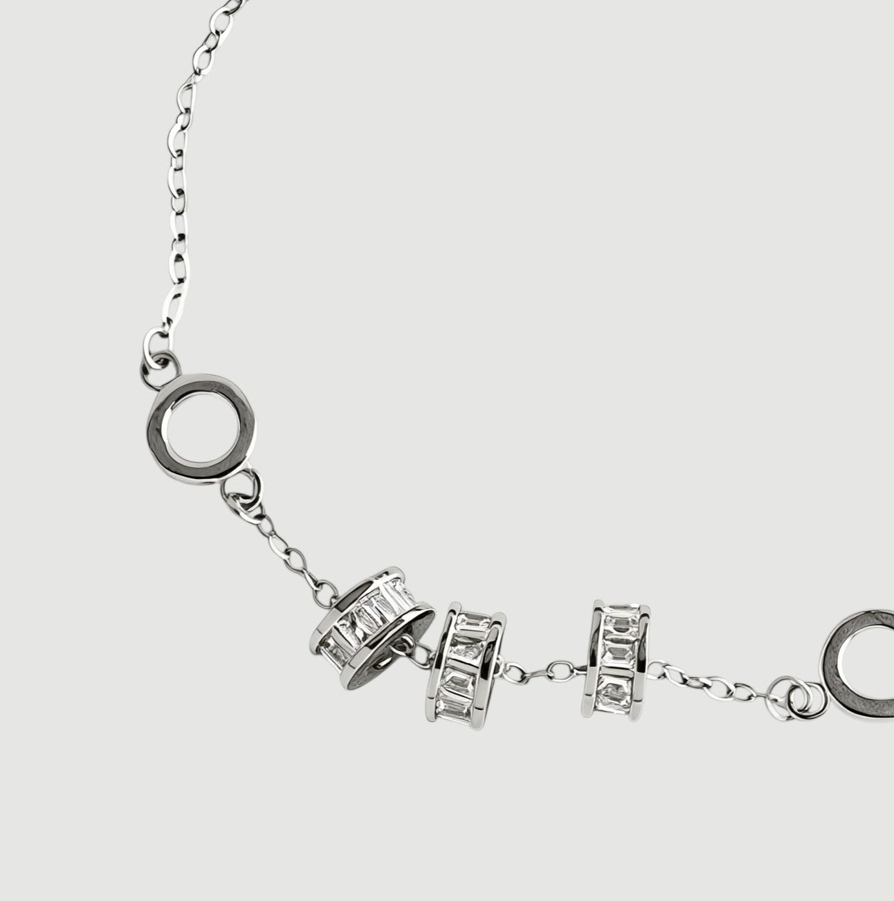 Amara Jewels 925 sterling silver bracelet with geometric charms and adjustable chain. Features circular and bar charms with baguette-cut stones.