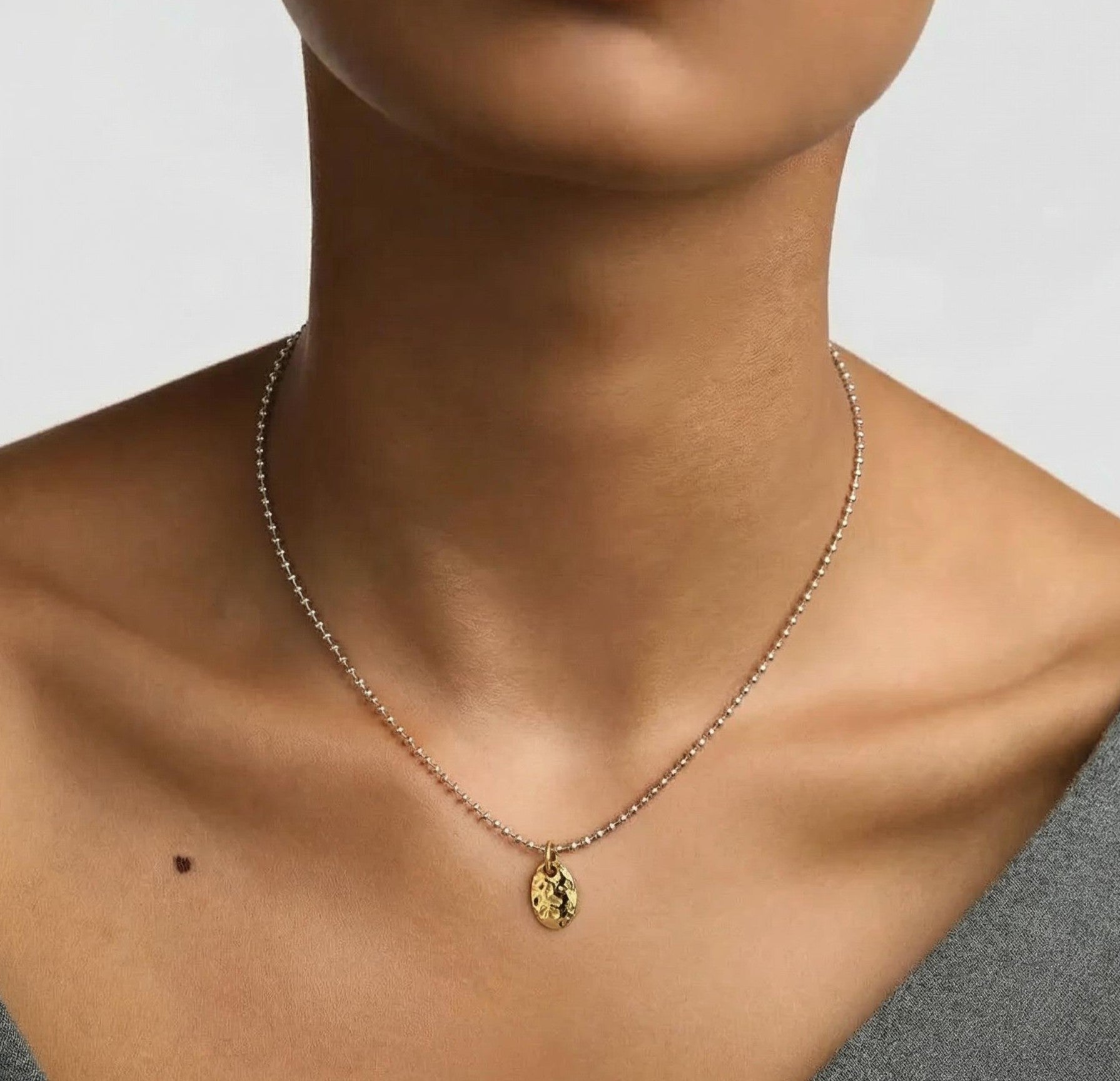 Amara Jewels sterling silver ball chain necklace with textured gold oval pendant embossed with 'LOVE'.