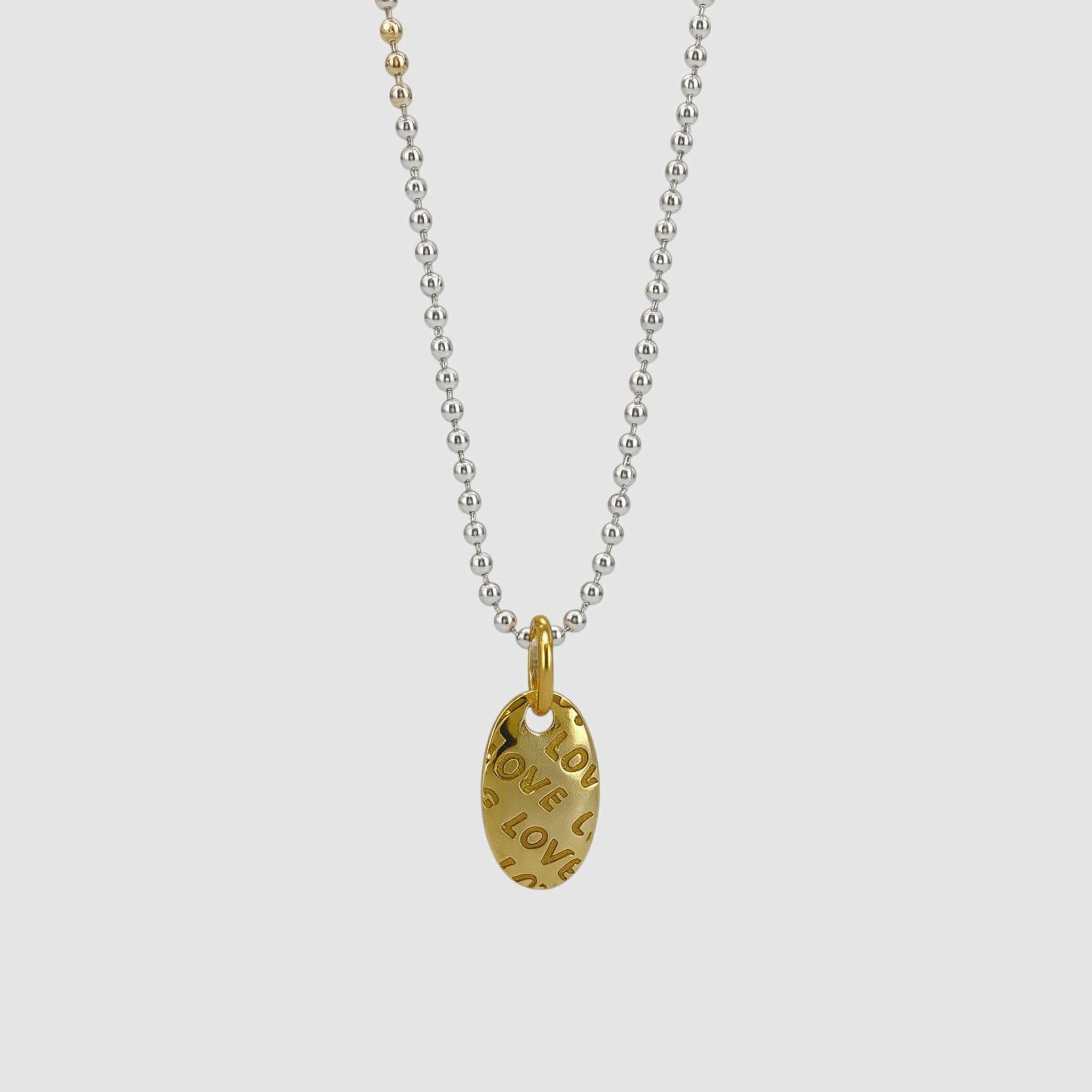 Amara Jewels sterling silver ball chain necklace with textured gold oval pendant embossed with 'LOVE'.