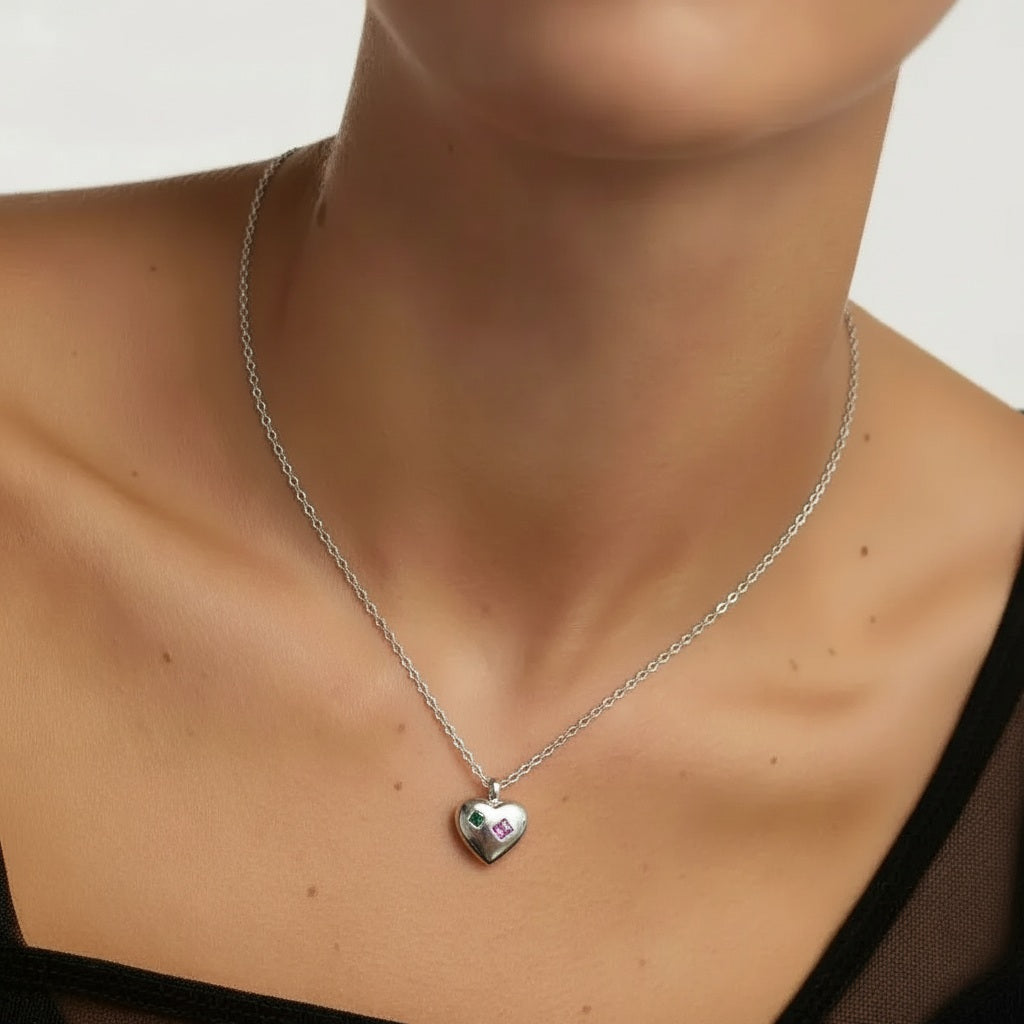 Amara Jewels sterling silver heart charm necklace with engraved red and green shapes.