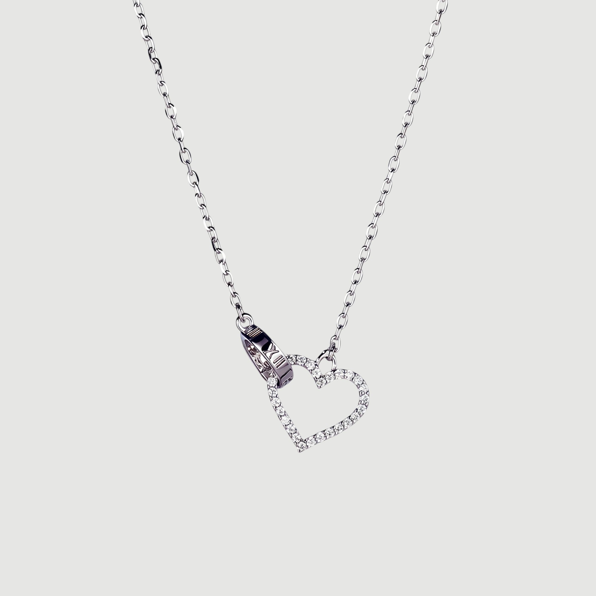 Amara Jewels sterling silver necklace with a linked open heart pendant adorned with cubic zirconia and a circle charm with Roman numerals.
