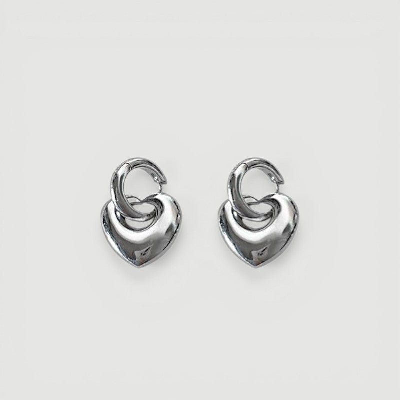 Amara Jewels Sterling Silver Bold Interlocking Heart Hoop Earrings. Polished silver, modern design.