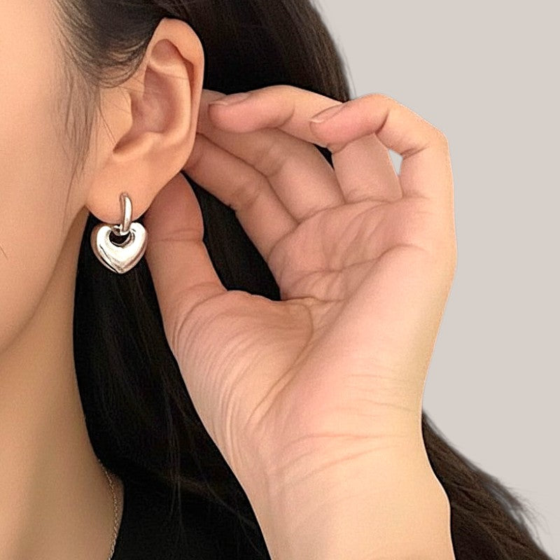 Amara Jewels Sterling Silver Bold Interlocking Heart Hoop Earrings. Polished silver, modern design.