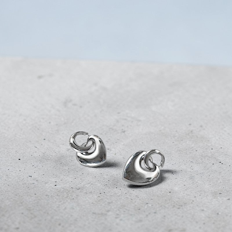 Amara Jewels Sterling Silver Bold Interlocking Heart Hoop Earrings. Polished silver, modern design.
