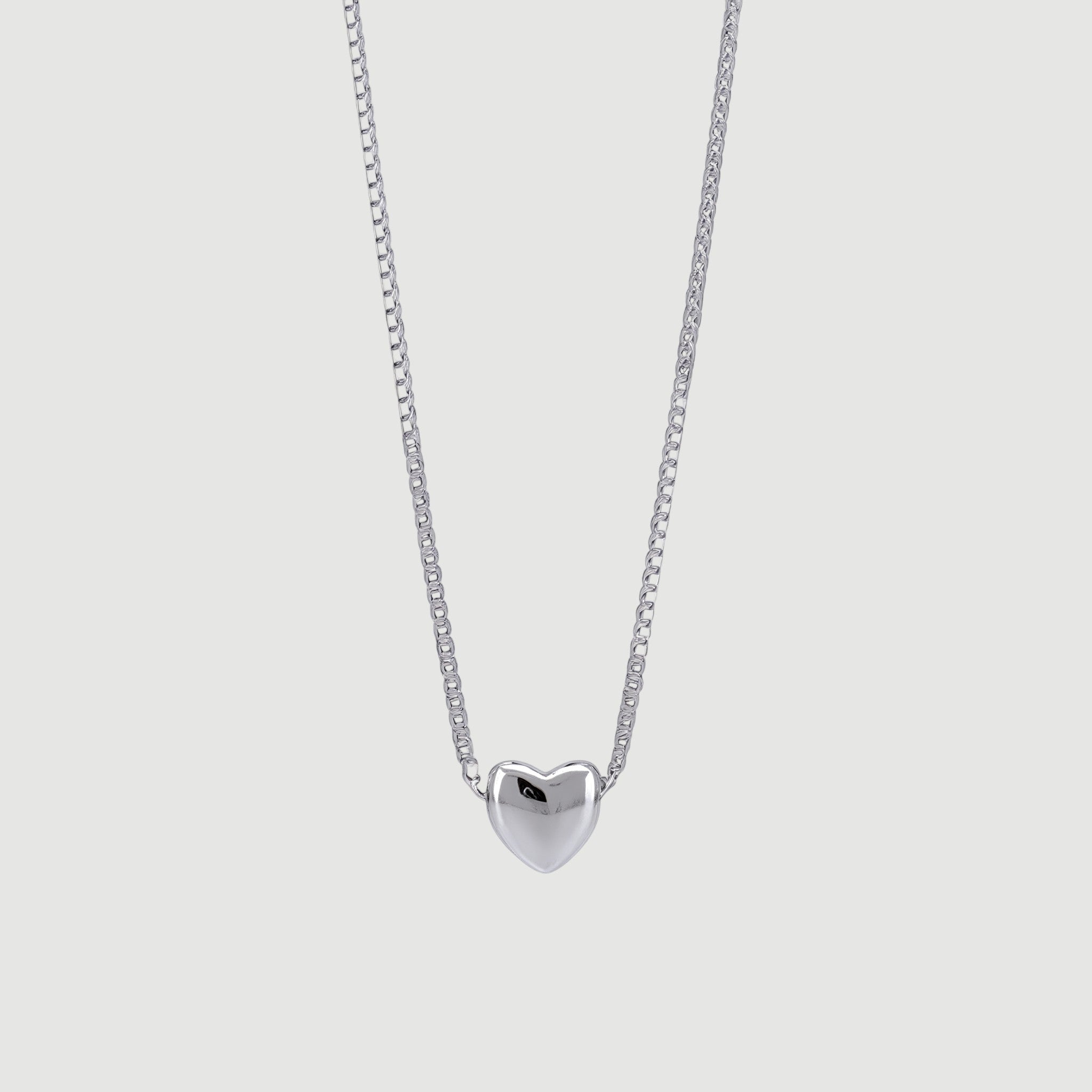 Amara Jewels minimalist sterling silver heart necklace with a delicate box chain. Polished silver pendant.