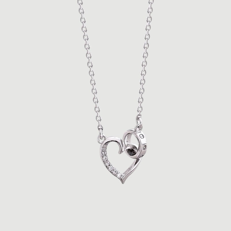 Amara Jewels silver 925 sterling necklace with a heart pendant adorned with crystals and an intertwined circle detail.
