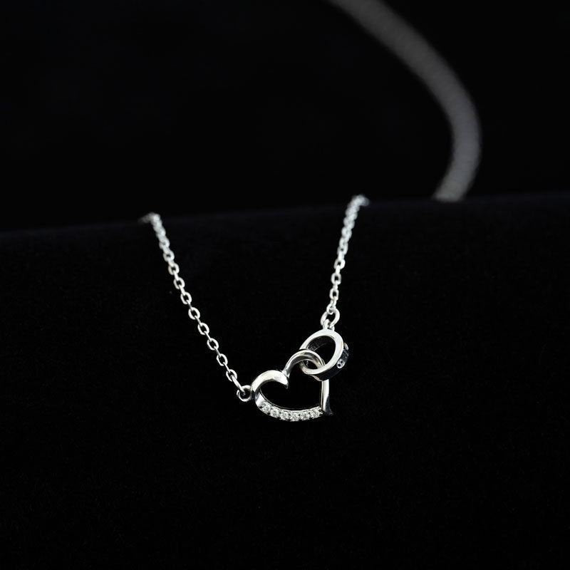 Amara Jewels silver 925 sterling necklace with a delicate heart pendant featuring crystal accents and an intertwined ring detail.