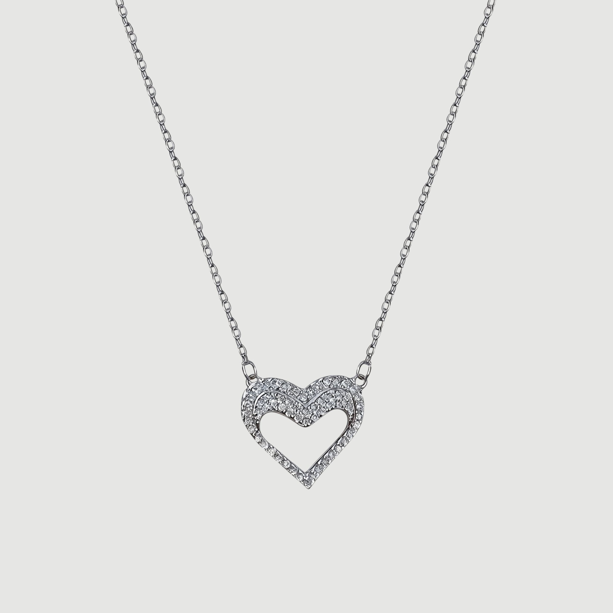 Amara Jewels silver hollow heart necklace with crystal embellishments, delicate chain.