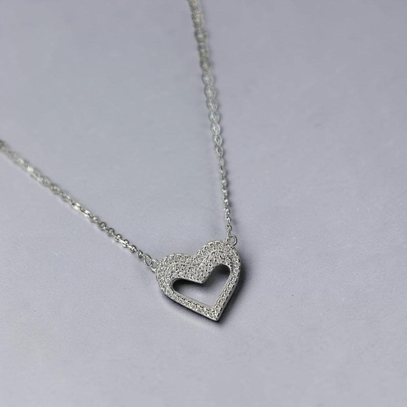 Amara Jewels silver hollow heart necklace with crystal embellishments, delicate chain.