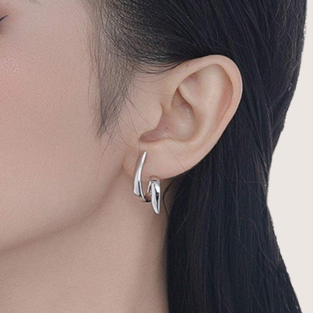 Amara Jewels silver-plated sterling silver twist pattern earrings with a modern, sculptural design.