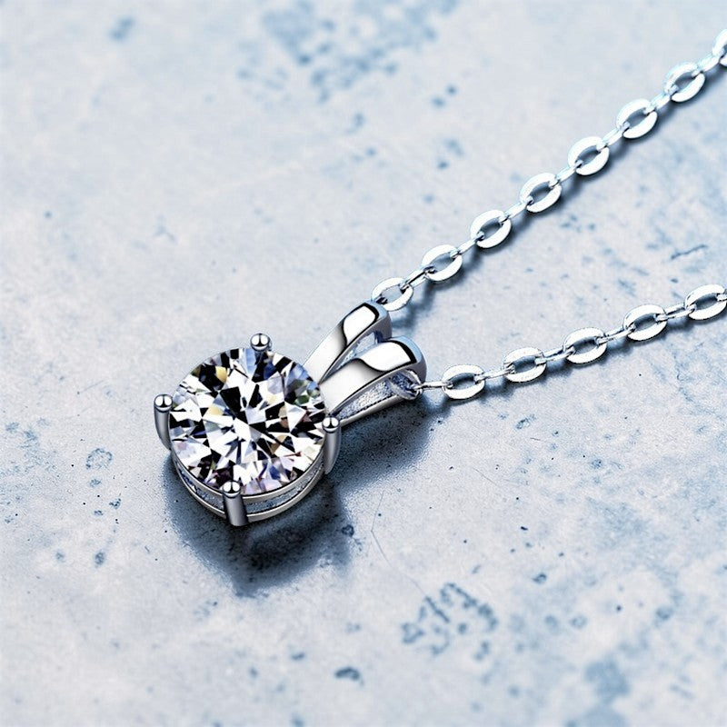 Amara Jewels 925 sterling silver solitaire pendant necklace with four-prong setting and a clear, round-cut gemstone.