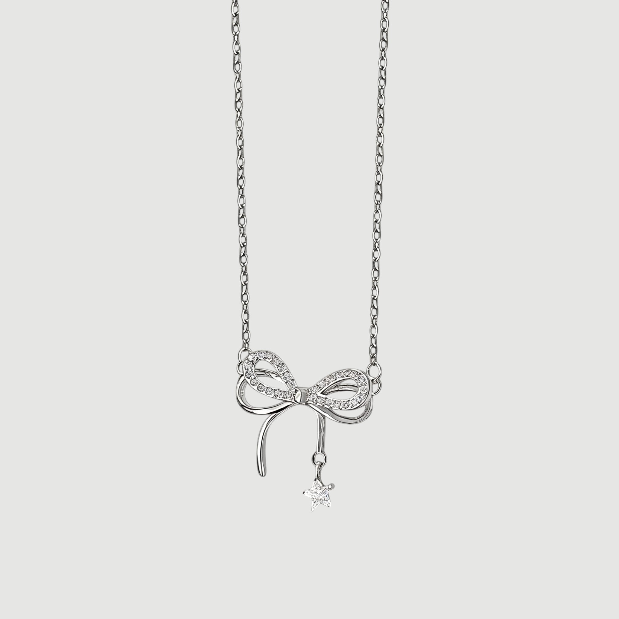Amara Jewels sterling silver necklace with a sparkling bow charm and dangling star pendant.