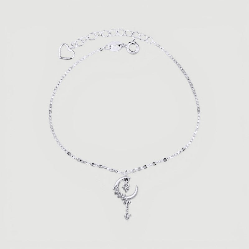 Amara Jewels sterling silver bracelet with a crescent moon and star charm, encrusted with cubic zirconia. Features a delicate chain and adjustable clasp.