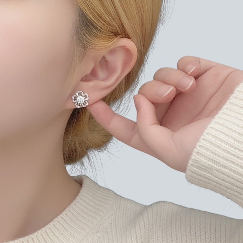 Amara Jewels sterling silver flower petal stud earrings with a central round stone, symbolizing love and elegance.