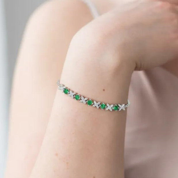 Amara Jewels sterling silver bracelet with green gemstones set in a flower design. Adjustable slider clasp.