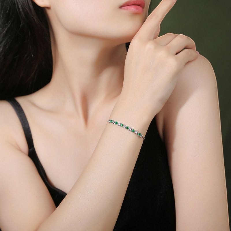 Amara Jewels sterling silver bracelet with green gemstones set in a flower design. Adjustable slider clasp.