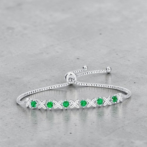 Amara Jewels sterling silver bracelet with green gemstones set in a flower design. Adjustable slider clasp.