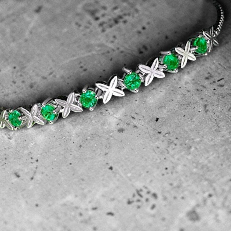 Amara Jewels sterling silver bracelet with green gemstones set in a flower design. Adjustable slider clasp.