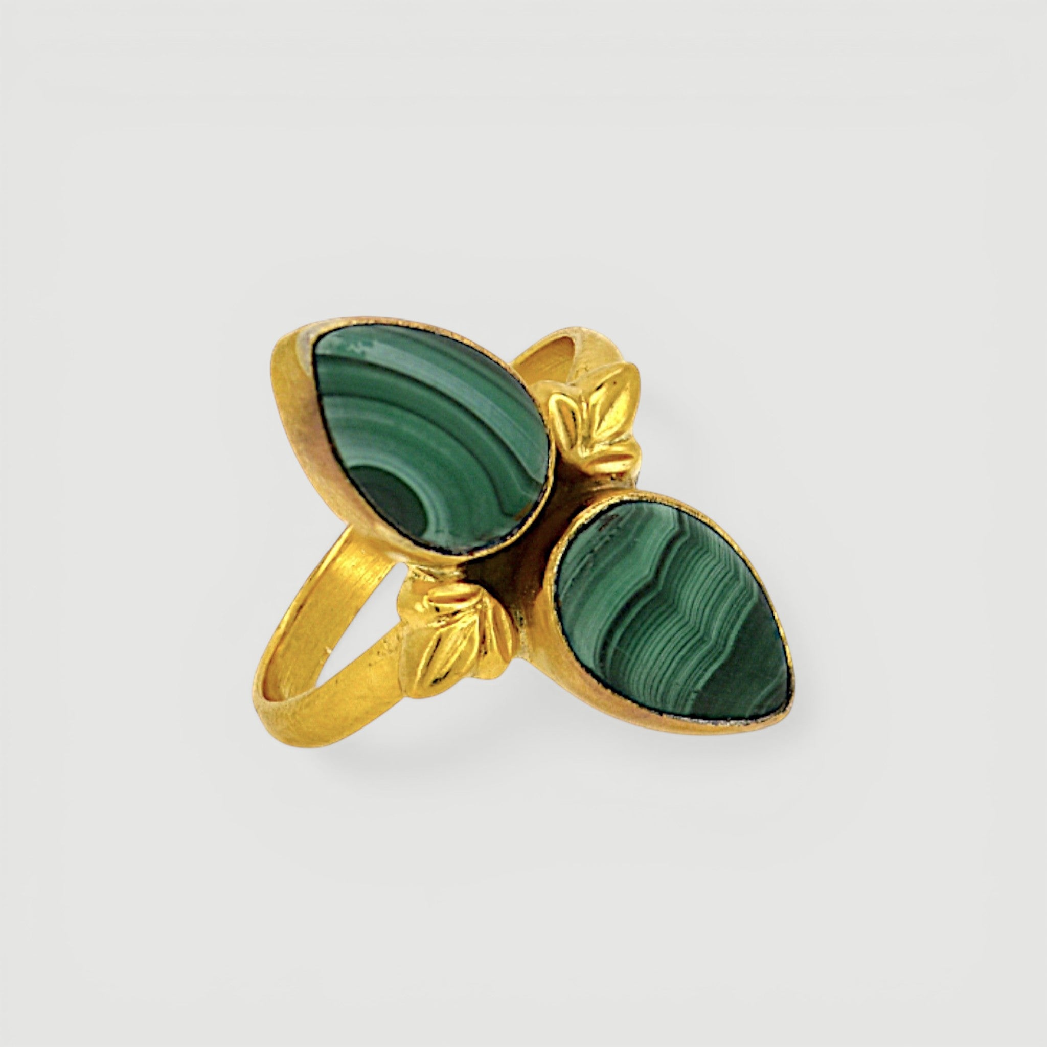 Amara Jewels green malachite statement ring in 18K gold vermeil over sterling silver. Features natural malachite gemstone with unique banding patterns.