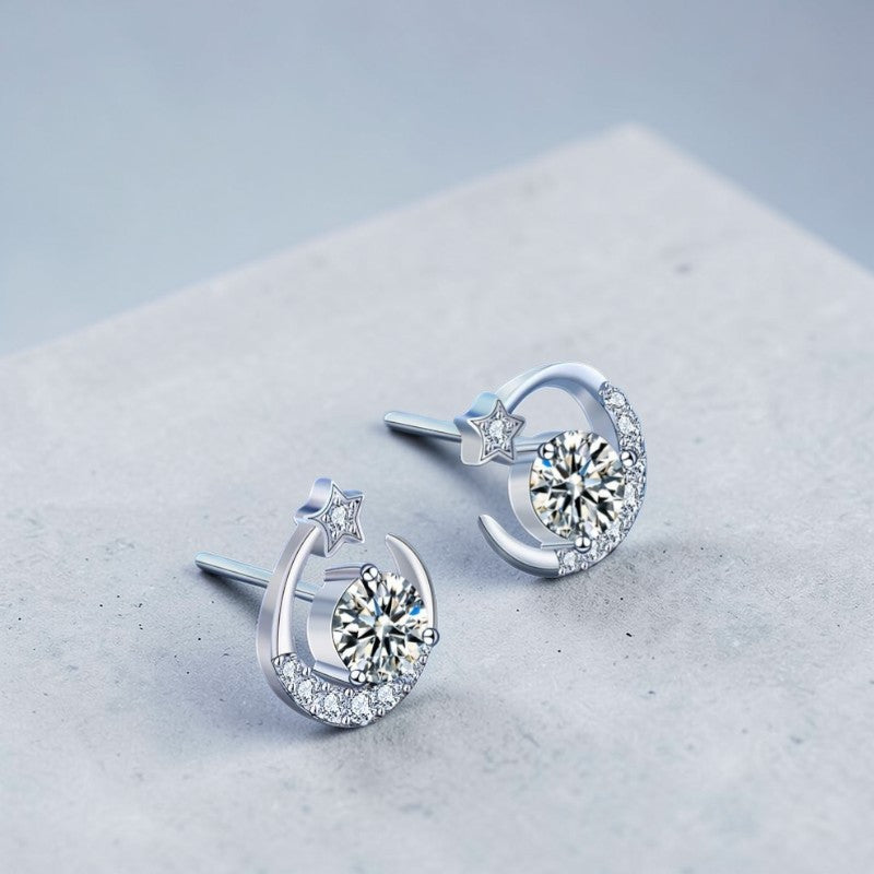 Amara Jewels Sterling Silver crescent moon stud earrings with star and clear crystals. Celestial design.