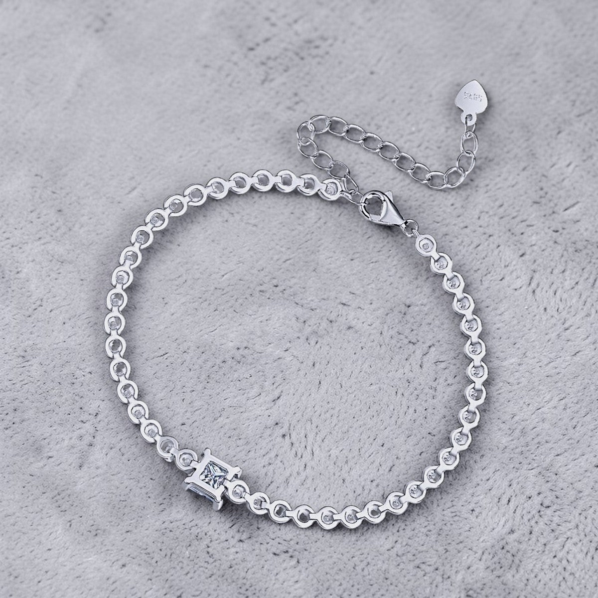Amara Jewels 925 sterling silver tennis bracelet with princess-cut zirconia centerpiece and round-cut stones.