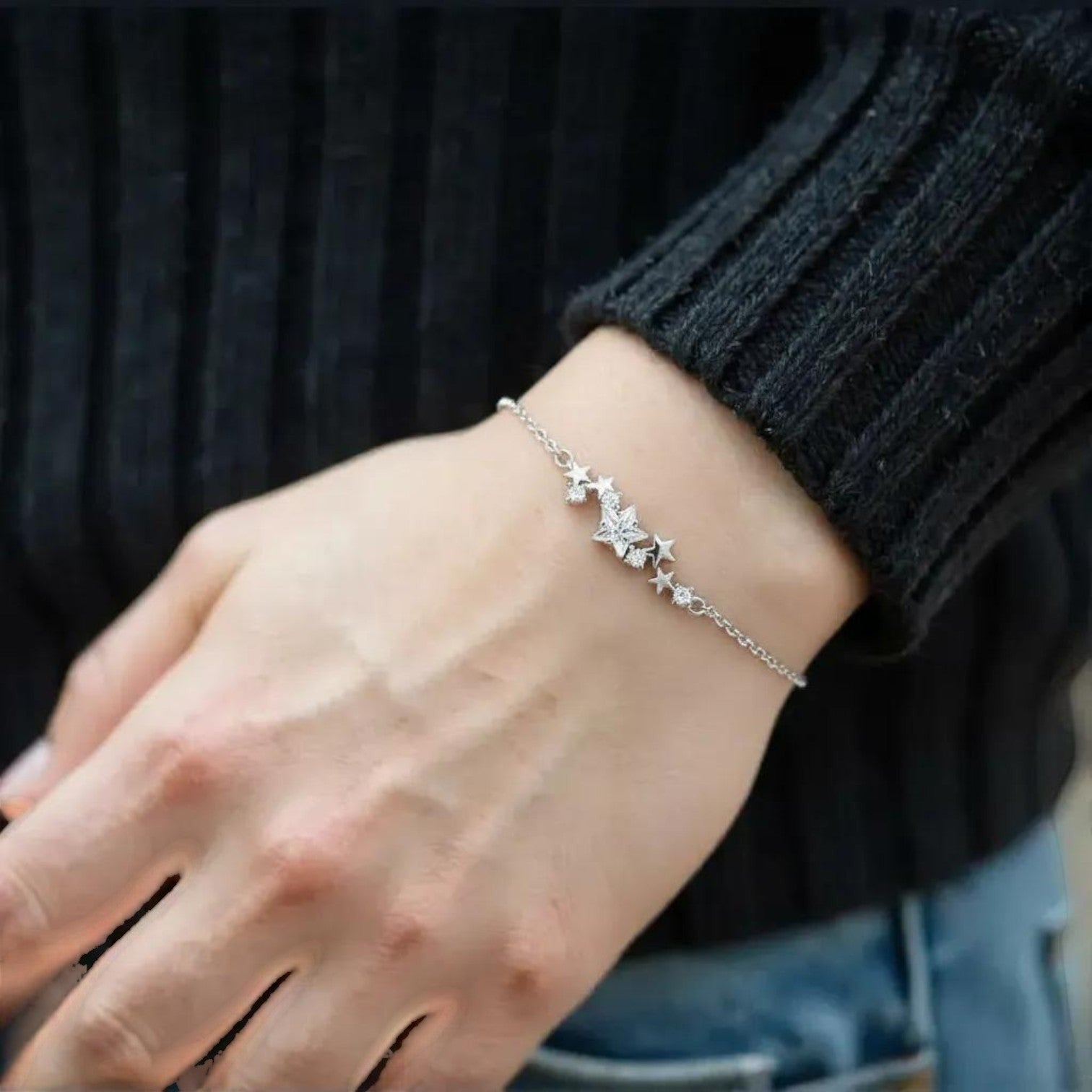 Amara Jewels sterling silver bracelet with a cluster of five sparkling cubic zirconia stars and an adjustable chain.