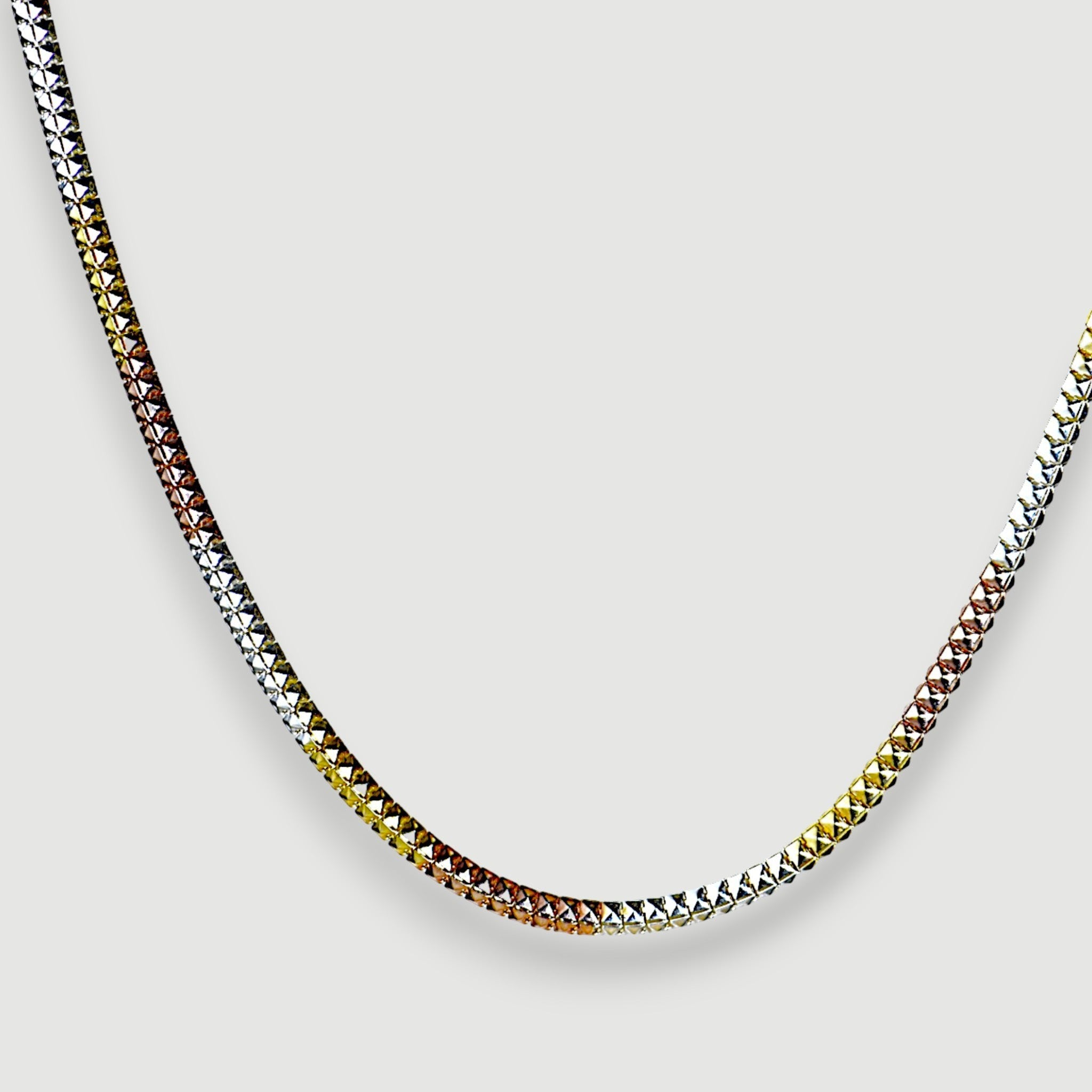 Amara Jewels Tricolor Italian chain necklace in sterling silver with diamond-cut texture, featuring silver, yellow gold, and rose gold tones.