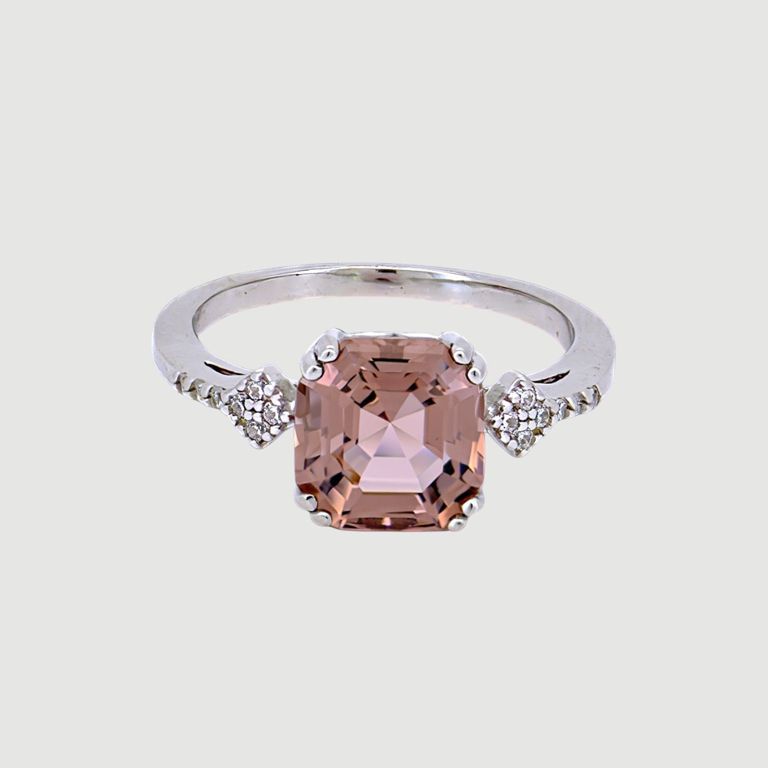 Amara Jewels 925 sterling silver ring with a square-cut pink sapphire and small zirconia accents on the band.