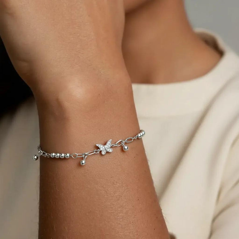 Amara Jewels sterling silver bracelet with delicate butterfly charms and polished silver beads, adjustable clasp.