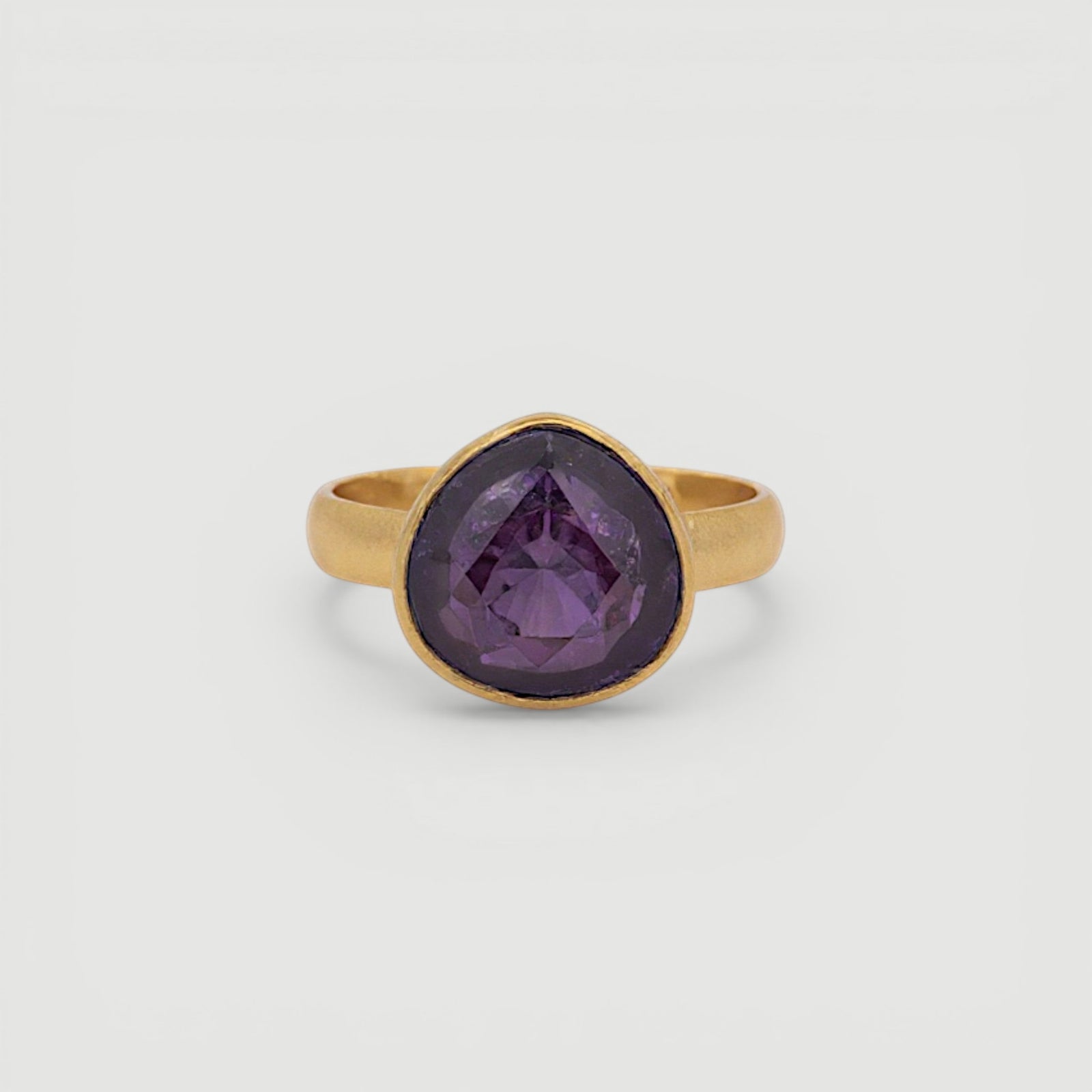 Amara Jewels 18K gold vermeil ring with a faceted deep violet amethyst gemstone in a bezel setting.