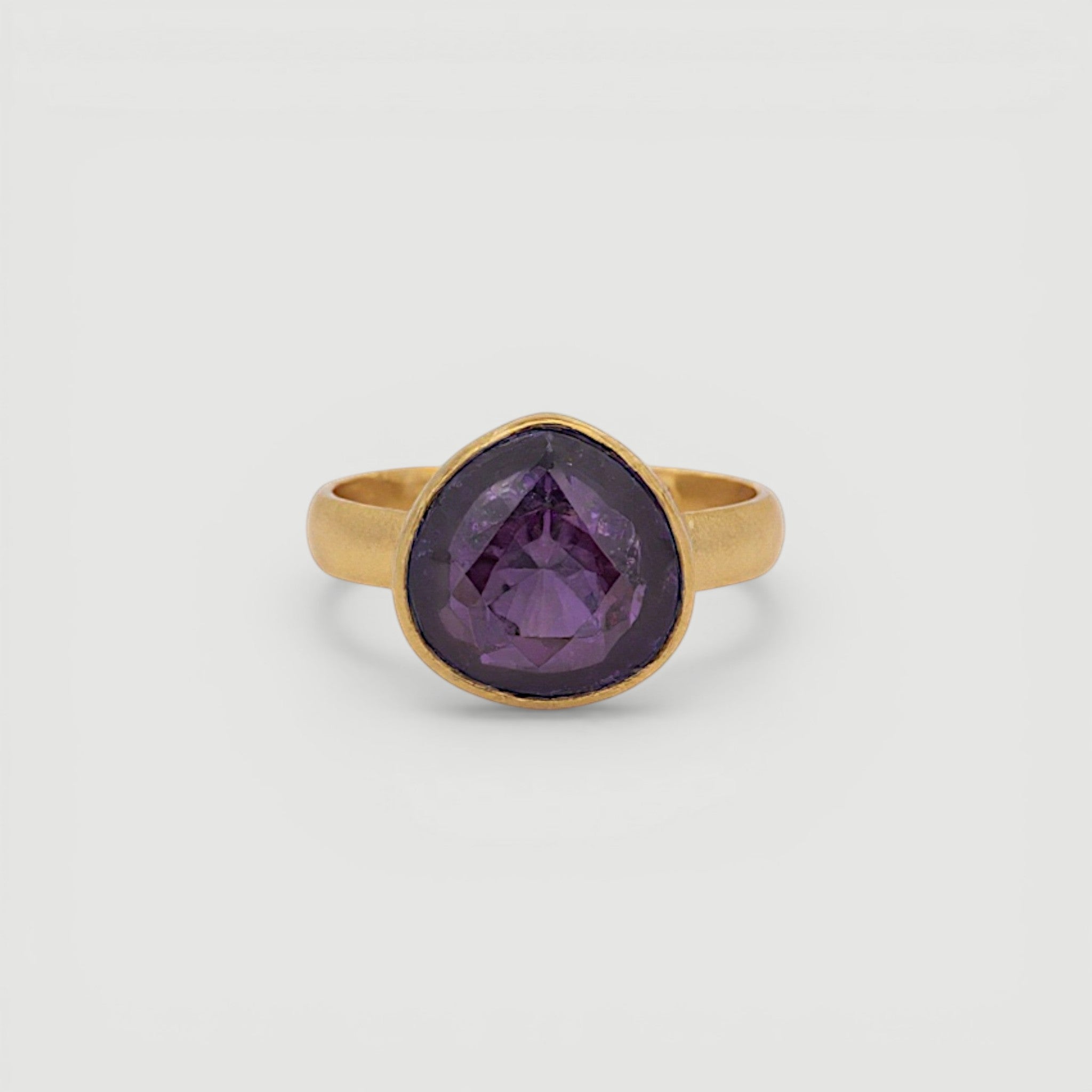 Amara Jewels 18K gold vermeil ring with a faceted deep violet amethyst gemstone in a bezel setting.